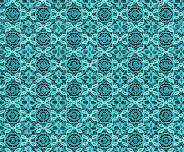 Seamless pattern in the form of turquoise lace on a black background. Lace with geometric motifs. Detailed texture of lace.