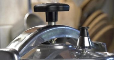 Düdüklü tencere vanası basıncı azaltır ve döndürür. Döner vana orta ölçekli bir çekim, deliklerden buhar ve su fışkırtır. Sığ alan derinliği.