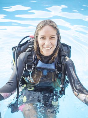 Çalışan anne, PADI Scuba dalış eğitmeni kadında ve havuz kenarı 