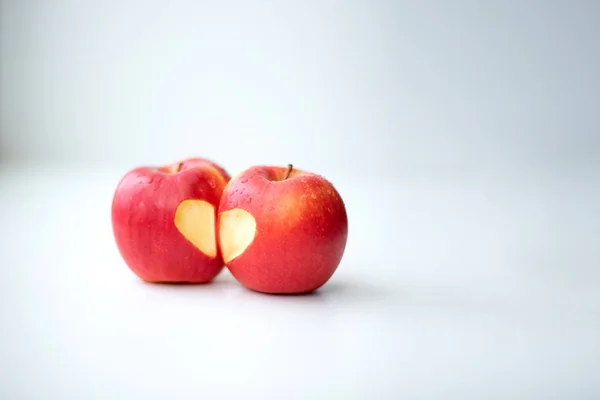 Love of apples concept with a neatly incised heart in the skin of a ripe red apple in St. Valentina\'s Day
