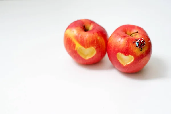 Love of apples concept with a neatly incised heart in the skin of a ripe red apple in St. Valentina's Day