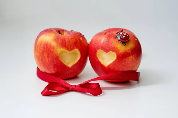 Love of apples concept with a neatly incised heart in the skin of a ripe red apple in St. Valentina\'s Day