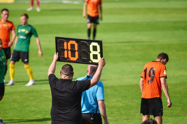 Team manager shows players substitution .