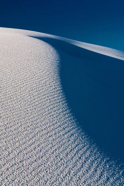 Closeup of the white sand dune showing a grainy sand texture