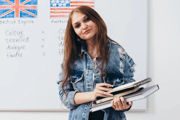 Female student with books in classroom English language school. — Stock Photo, Image