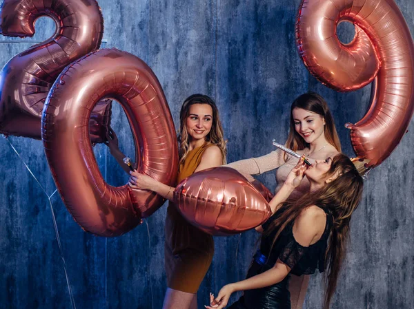 Schöne junge Frauen, die mit Luftballons spielen. Neues Jahr, Weihnachten, Weihnachten — Stockfoto