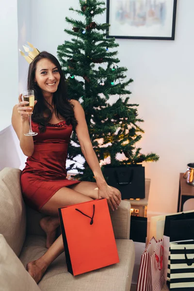 Young woman with shopping bags near Christmas tree. — Stock Photo, Image