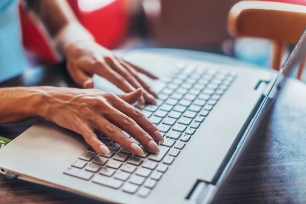 Close-up shot of female hands typing on laptop keyboard — Stock Photo, Image