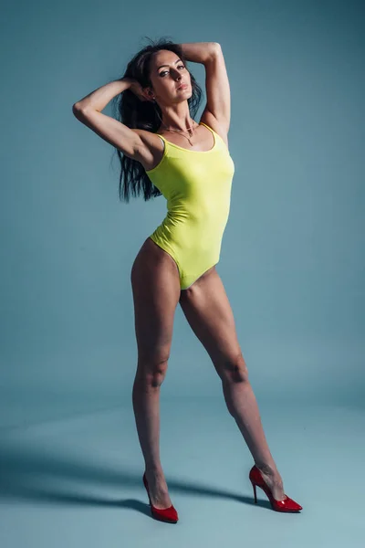 Young woman with perfect body posing in studio — Stock Photo, Image