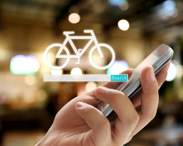 Hand of businessman holding a smartphone and have bicycle symbol to search for design in your work marketing concept.