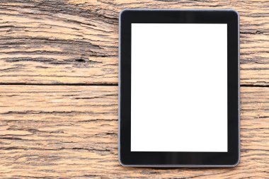 Tablet kahverengi ahşap zemin üzerinde boş ve iş kavramı tasarımında için kopya alanınız.