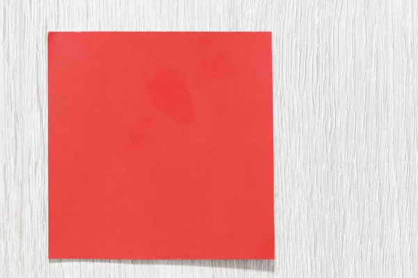 empty red art paper on a white wooden floor for design in Christmas concept.