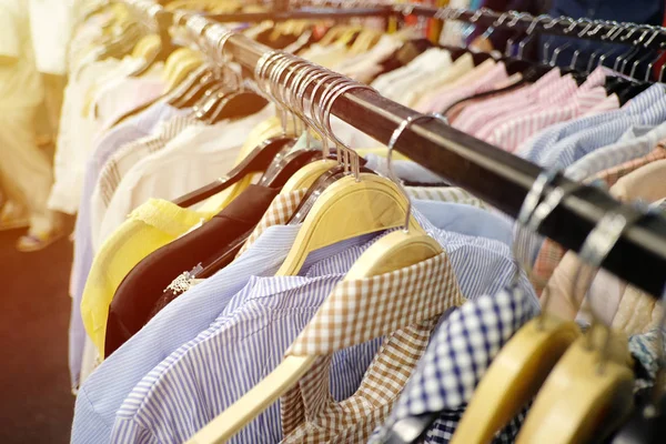 Colorful clothes hanging on clothesline and have orange sunlight