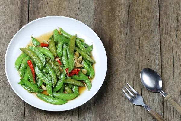 Green string bean fried oyster sauce of Thai foods on wooden flo — Stock Photo, Image