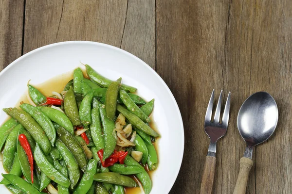 Green string bean fried oyster sauce of Thai foods on wooden flo — Stock Photo, Image