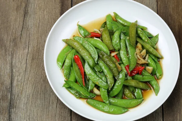 Green string bean fried oyster sauce of Thai foods on wooden flo — Stock Photo, Image