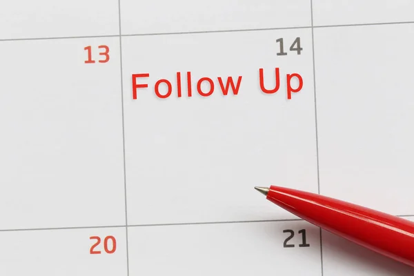 Red pen point to a empty space on the calendar and have follow u — Stock Photo, Image