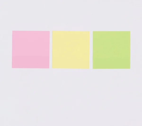 Colorful square note paper on white paper background and have copy space for you design.