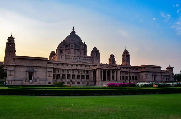 View of the Umaid Bhawan palace and hotel against a setting sun in Jodhpur, Rajasthan, India. This elegant hotel in a grand building was once home to the Jodphur royal family