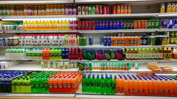 Cold drinks, juices, water, soda etc from popular FMCG brands displayed on aisle in a modern grocery outlet at a mall, Delhi, India, circa 2019