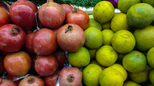Oranges and pomegranate kept at a shopping store in Delhi, India