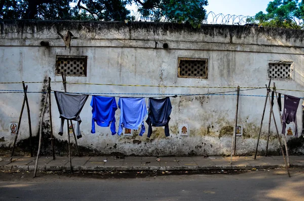 clothes hanging on makeshift tents in streets of central delhi.