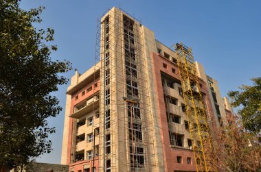Under construction high rise office complex against skyline of Gurgaon, Noida, Mumbai, Delhi NCR. These modern housing cum office real estate projects boast modern architecture