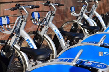handles of smart bikes stacked together in parking