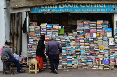 old couple browsing books at a road side book shop in CP