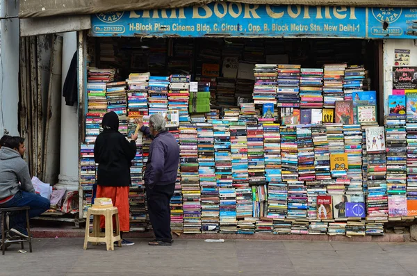 old couple browsing books at a road side book shop in Connaught Place