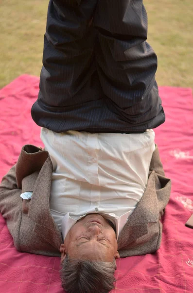 old Indian man doing yoga