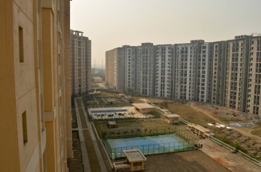 Under construction multistorey residential building complex in Delhi, Navi Mumbai, Jaipur, Pune, Kolkata, Mumbai, Gurgaon, Greater Noida, Bangalore, Lucknow, India clipart