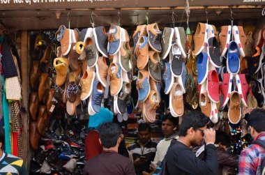 hanging shoes outside store front in old delhi