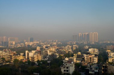ariel view of the noida skyline dotted with row houses and big rise multistory buildings in the background