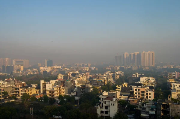 ariel view of the noida skyline dotted with row houses and big rise multistory buildings in the background