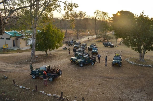 Uttarakhand, India, 2019. Top view of a group of gypsy cars offroading vehicles with people waiting to begin their safari in Jim Corbett National Park tiger reserve