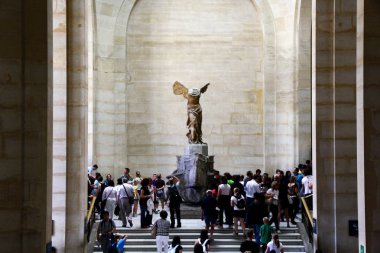 Crowds gathered around statue of Winged Victory of Samothrace, also called the Nike of Samothrace, Louvre, Paris