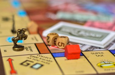 metal horse piece and dice on a board game