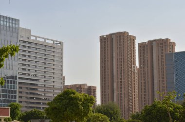 High rise office complex and residential complex against skyline of Delhi NCR. These modern housing cum office real estate projects boast modern architecture
