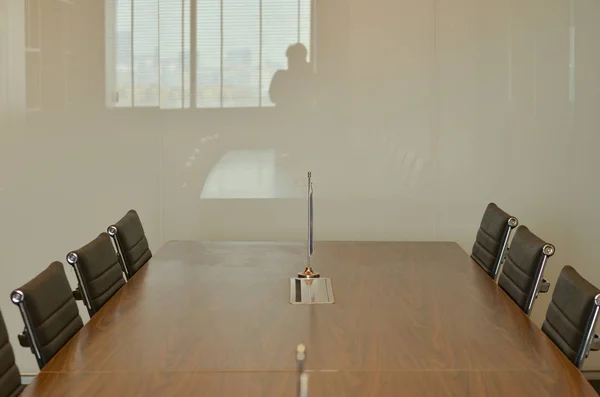 Board room in a modern office with wooden table and white board.The white walls and modern look makes this a perfect place to showcase corporate setup