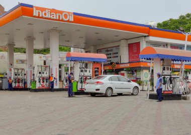 New Delhi, India, 2020. Petrol / Diesel being filled into a car at an Indian Oil Petrol Pump to get tank full and pollution checking centers to get PUC. Price hike is considered indicator of economy clipart