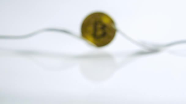 Slide zoom in focus shot of Bitcoin fork concept on the white background with reflection — Stock Video