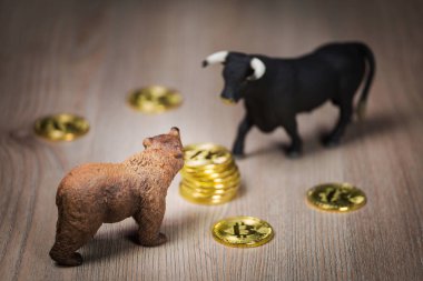 Cryptocurrency bitcoin ayı ve boğa figürleri ahşap bir masaya. Kaba veya boğa piyasası eğilim kavramı