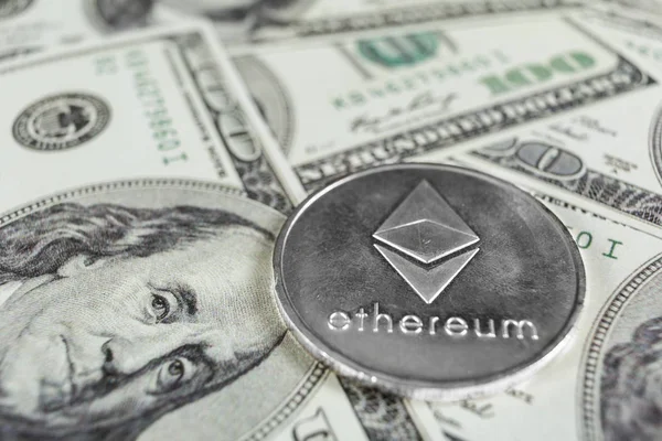 Silver Ethereum on hundred dollars bills. Close-up, macro shot. — Stock Photo, Image