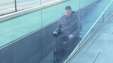 4k Tekerlekli sandalyedeki adam bir rampa kullanıyor.
