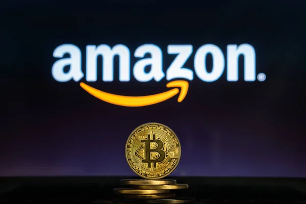 Amazon logo Bitcoin cryptocurency para yığını ile bilgisayar ekranında.