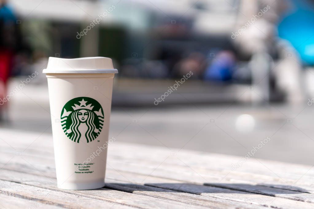 Slovenia 27.2.2019 - Starbucks take away, hot beverage coffee cup with logo, on the table in store. With shallow depth of field