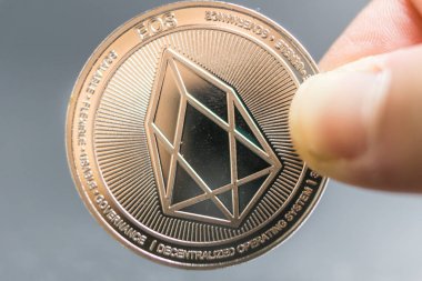 EOS, Crypto currency silver coin, Macro shot of Iota coin isolated on background, cut out Blockchain technology,