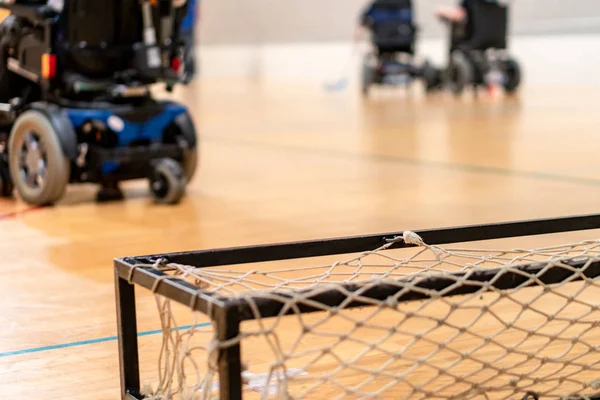 Disabled people on an electric wheelchair playing sports, powerchair hockey. IWAS - International wheelchair and amputee sports federation — Stock Photo, Image