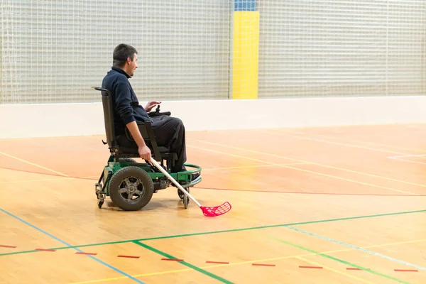 Disabled man on an electric wheelchair playing sports, powerchair hockey. IWAS - International wheelchair and amputee sports federation — Stock Photo, Image